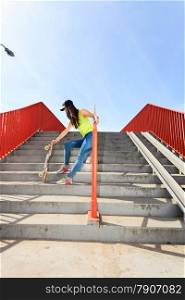 Summer sport and active lifestyle. Cool teenage girl skater with skateboard on the stairs. Outdoor.