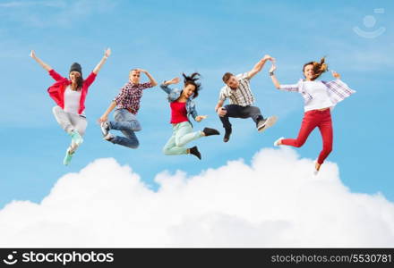 summer, sport, dancing and teenage lifestyle concept - group of teenagers jumping