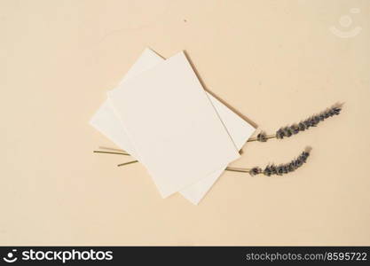 summer stationery mock-up scene. Blank business card with lavender flowers on beige textured table background. Flat lay, top view. summer stationery mock-up scene.