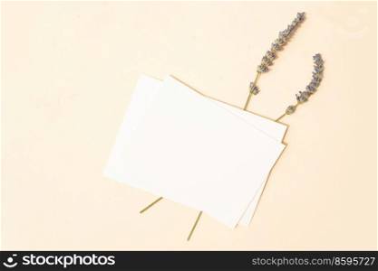 summer stationery mock-up scene. Blank business card with lavender flowers on beige textured table background. Flat lay, top view. summer stationery mock-up scene.