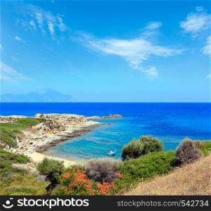 Summer stony sea coast landscape with Athos mount view in far, Halkidiki, Sithonia, Greece.