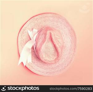 Summer straw hat on pastel color background. Top view
