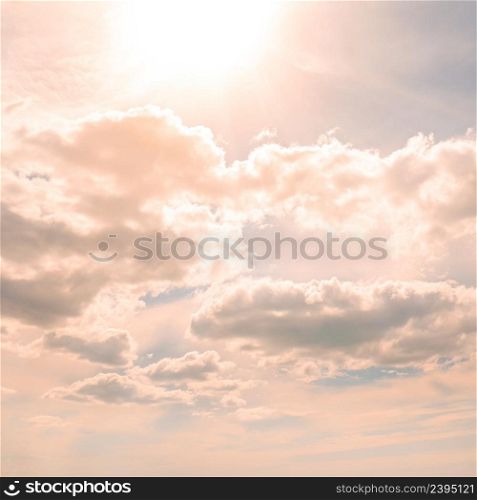 Summer sun in sky with white clouds.