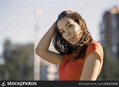 Summer sunny lifestyle fashion portrait of young woman posing in the city. Summer sunny lifestyle fashion portrait of young woman posing in the city.