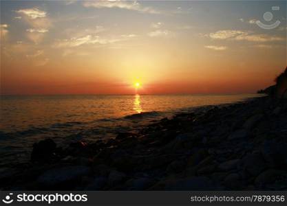 Summer sunset on the beach of the sea