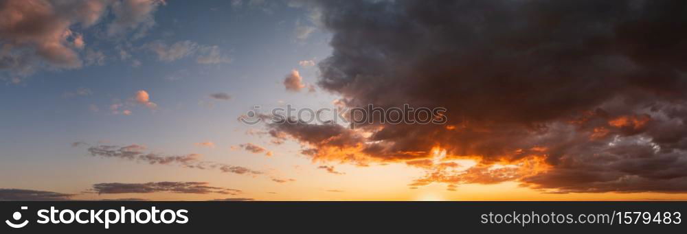 Summer sunset sky high resolution panorama with fleece colorful clouds. Evening dusk good weather natural background.