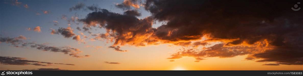 Summer sunset sky panorama with fleece colorful clouds. Evening dusk good weather natural high resolution background.