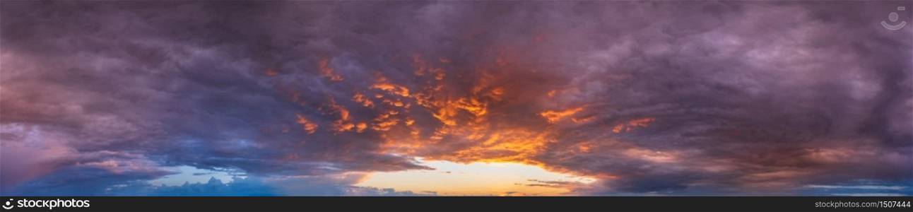 Summer sunset sky panorama with fleece purple clouds. Evening dusk good weather natural background.