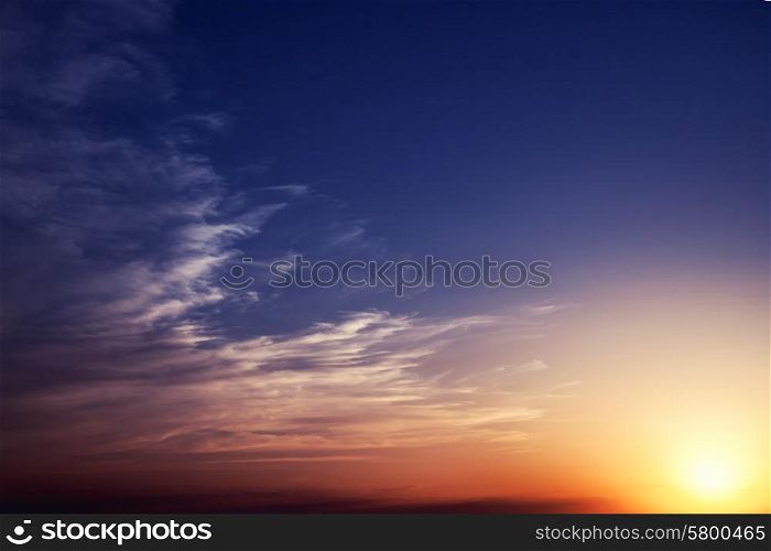 Summer sunset sky with clouds and sun