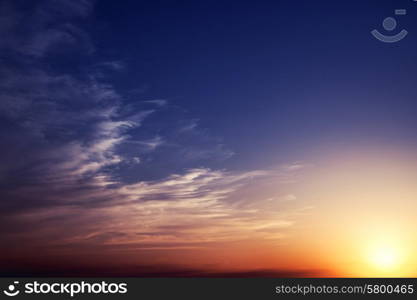 Summer sunset sky with clouds and sun