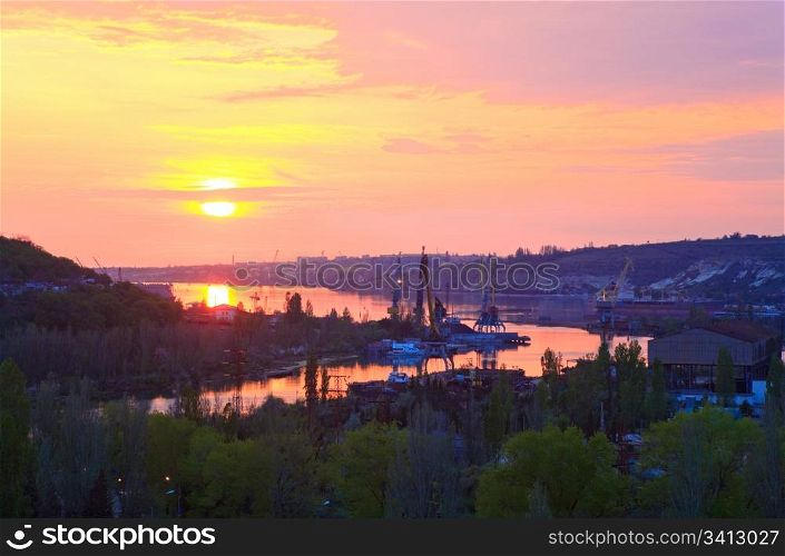 Summer sunset view of Sevastopol Town environs (Crimea, Ukraine) and small sea bay behind