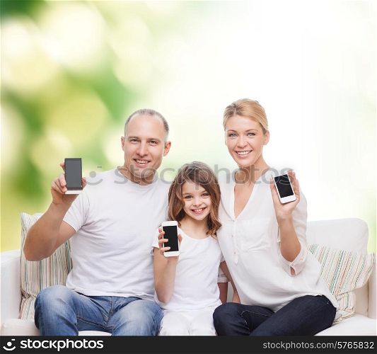 summer, technology, advertisement and people concept - smiling family with smartphones over green background