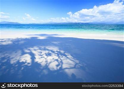 Summer time, leaf shade on white sand beach under the sunshine and blue sky. Khang Khao Island, Laem Son National Park. Ranong Province. South Thailand.