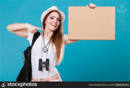 Summer tourism active lifestyle concept. Woman happy female tourist hitchhiking with blank sign cardboard on blue