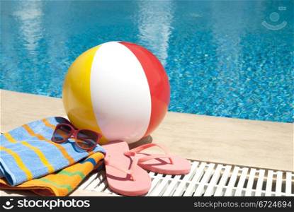Summer vacation accessoires by the swimming pool