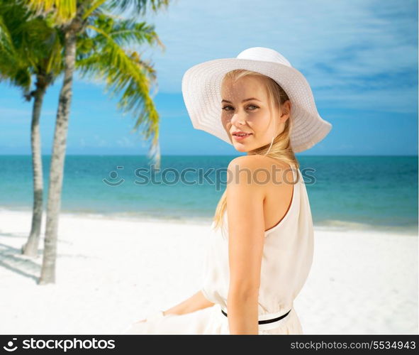 summer, vacation and lifestyle concept - beautiful woman in hat enjoying summer outdoors