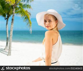 summer, vacation and lifestyle concept - beautiful woman in hat enjoying summer outdoors