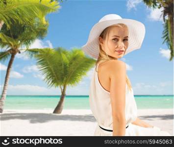 summer, vacation and lifestyle concept - beautiful woman in hat enjoying summer outdoors