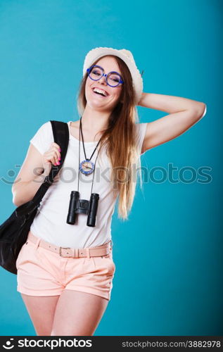 Summer vacation and tourism concept. Smiling woman in straw hat with backpack binocular compass on blue portrait