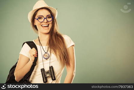 Summer vacation and tourism concept. Smiling woman in straw hat with backpack binocular compass on blue portrait