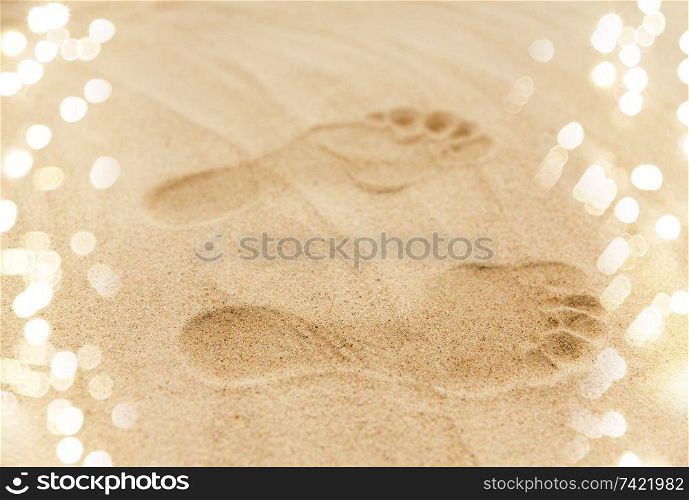 summer vacation concept - footprints in sand on beach. footprints in sand on summer beach