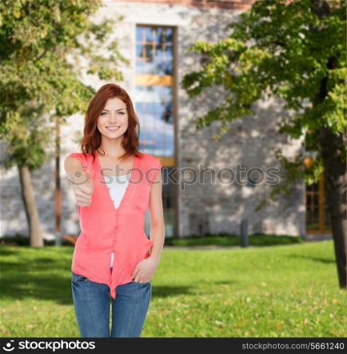 summer vacation, education, gesture and people concept - smiling teenage girl in casual clothes showing thumbs up over campus background