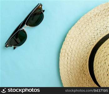 Summer vacation. Hat and sunglasses on a blue background. Background for advertising.