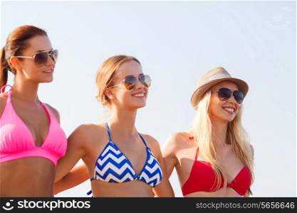 summer vacation, holidays, friendship and people concept - group of smiling young women in sunglasses