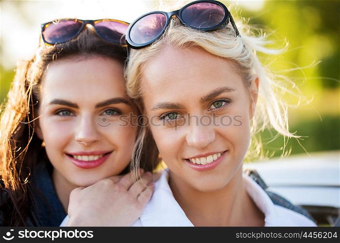summer vacation, holidays, friendship and people concept - happy smiling young women or teenage girls outdoors