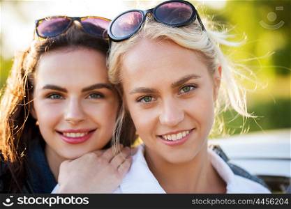 summer vacation, holidays, friendship and people concept - happy smiling young women or teenage girls outdoors