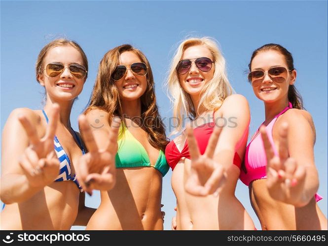 summer vacation, holidays, gesture, travel and people concept - group of smiling young women showing peace or victory sign over blue sky