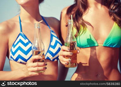 summer vacation, holidays, party, travel and people concept - close up of young women drinking lemonade on beach