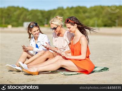 summer vacation, holidays, technology, travel and people concept - group of happy young women with smartphones on beach