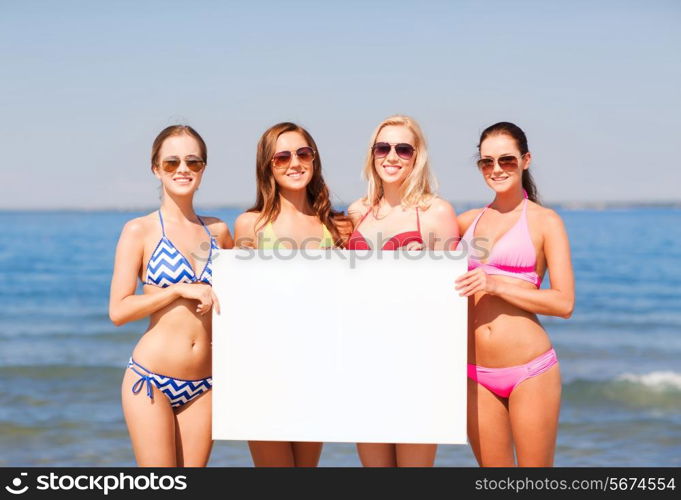 summer vacation, holidays, travel, advertising and people concept - group of smiling young women with big white blank billboard on beach