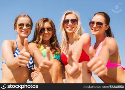 summer vacation, holidays, travel and people concept - group of smiling young women showing thumbs up over blue sky background