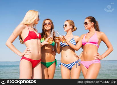 summer vacation, holidays, travel and people concept - group of smiling young women sunbathing and drinking on beach