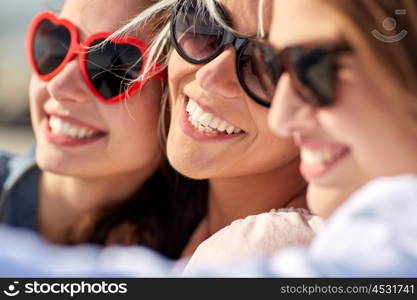 summer vacation, holidays, travel and people concept- group of smiling young women taking selfie on beach