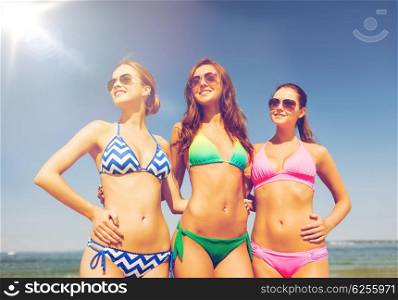 summer vacation, holidays, travel and people concept - group of smiling young women on beach