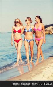 summer vacation, holidays, travel and people concept - group of smiling young women on beach
