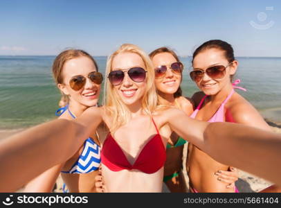 summer vacation, holidays, travel and people concept - group of young smiling women photographing by camera or smartphone on beach