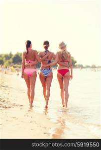 summer vacation, holidays, travel and people concept - group of young women on beach from back