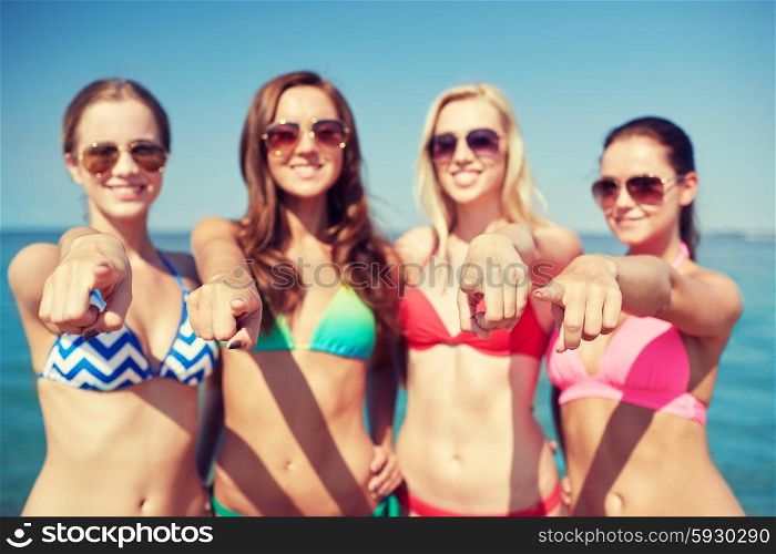 summer vacation, holidays, travel, gesture and people concept - group of happy young women pointing finger on you on beach