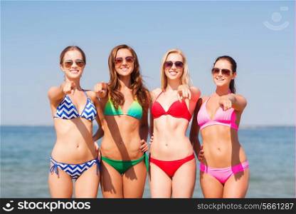 summer vacation, holidays, travel, gesture and people concept - group of smiling young women pointing finger on you on beach