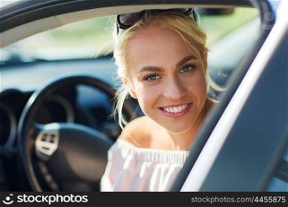 summer vacation, holidays, travel, road trip and people concept - happy smiling teenage girl or young woman in car