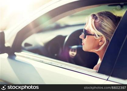 summer vacation, holidays, travel, road trip and people concept - happy smiling teenage girl or young woman in car. happy teenage girl or young woman in car
