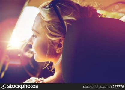 summer vacation, holidays, travel, road trip and people concept - happy teenage girl or young woman in car