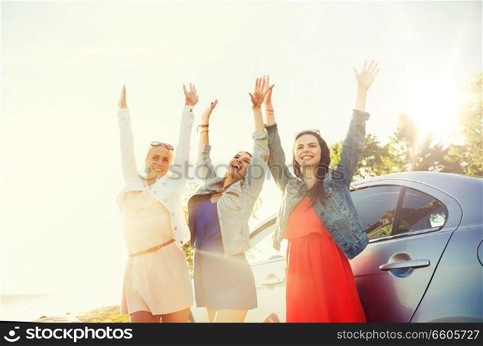 summer vacation, holidays, travel, road trip and people concept - happy teenage girls or young women near car at seaside. happy teenage girls or women near car at seaside