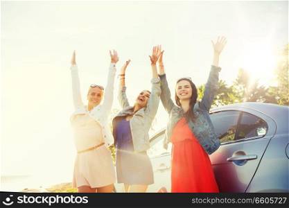 summer vacation, holidays, travel, road trip and people concept - happy teenage girls or young women near car at seaside. happy teenage girls or women near car at seaside