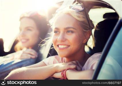 summer vacation, holidays, travel, road trip and people concept - happy teenage girls or young women in car at seaside. happy teenage girls or women in car at seaside