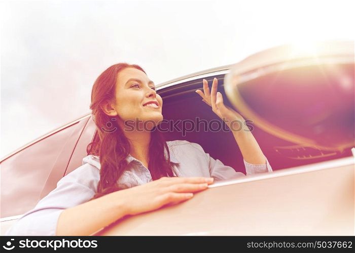 summer vacation, holidays, travel, road trip and people concept - happy young woman driving in car. happy young woman driving in car